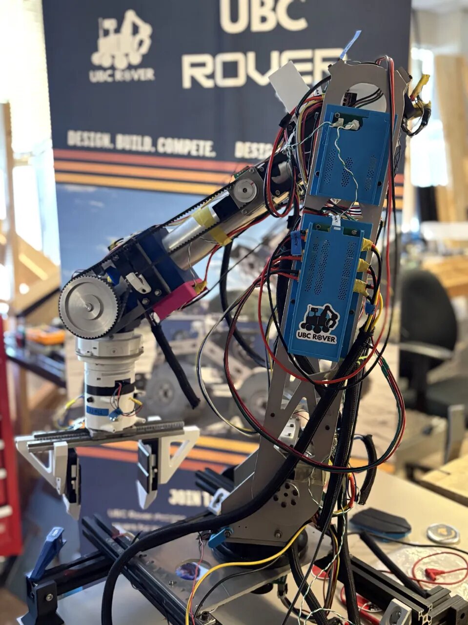 The arm on the bench, wiring exposed.